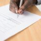 Person signing real estate closing documents